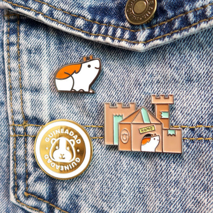 custom enamel pins consist of cute guinea pig enamel pin and a enamel pin of a guinae pig in hideout